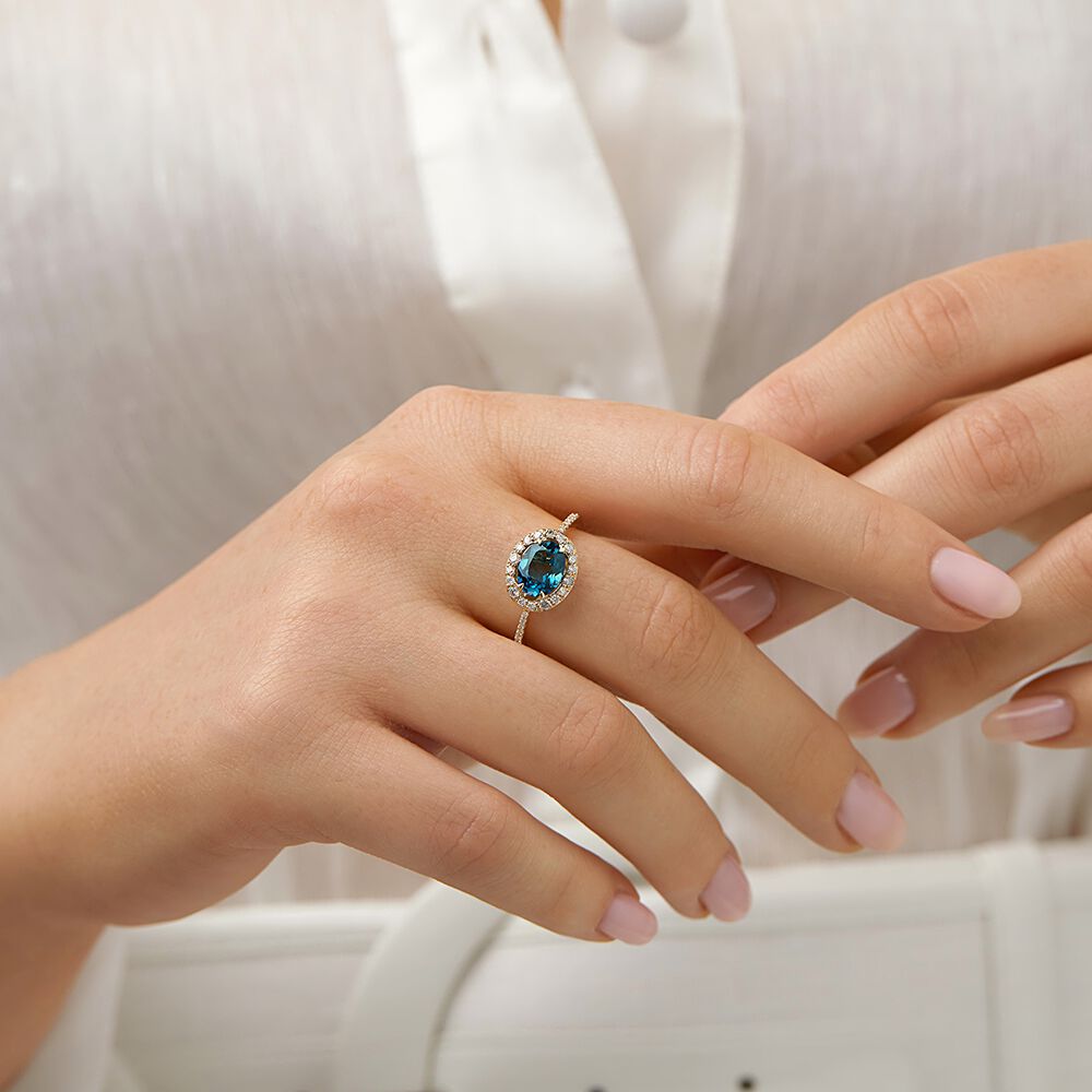 Halo Ring with London Blue Topaz & 0.25 Carat TW of Diamonds in 10kt Yellow Gold