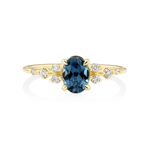 Ring with Blue Topaz and 0.12 Carat TW of Diamonds in 10kt Yellow Gold